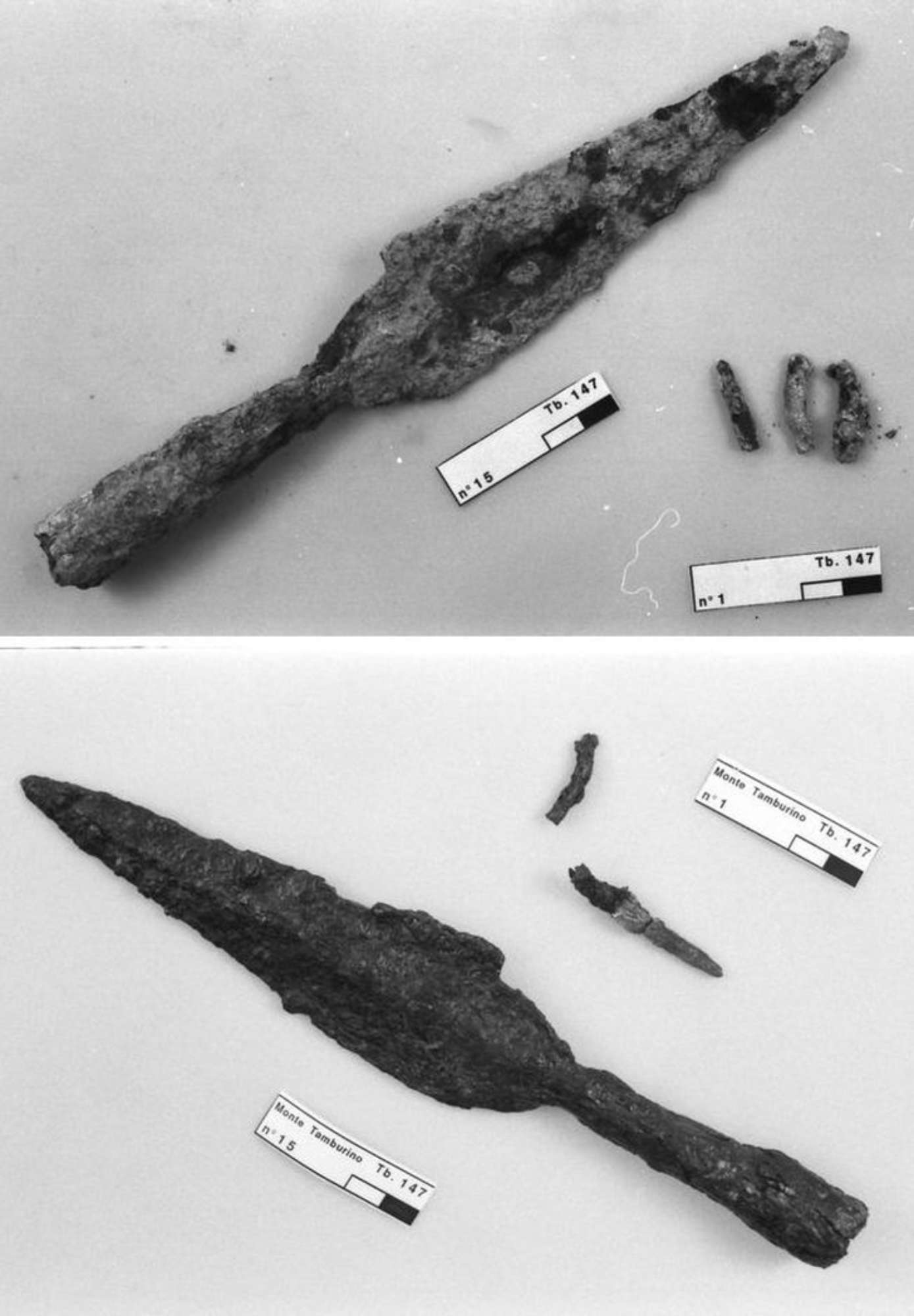 cimasa di candelabro in ferro in tre frammenti, cusipide di lancia in ferro prima del restauro